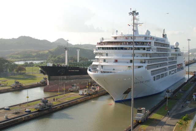 A cruise ship and cargo ship preparing to enter the locks.