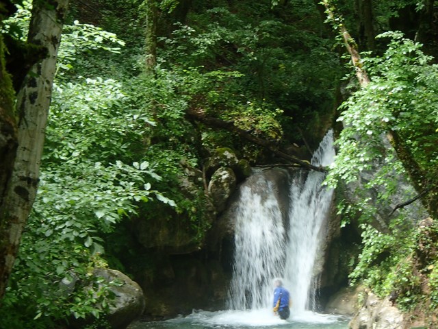 Kyle taking a quick shower in a waterfall along our rafting trip.