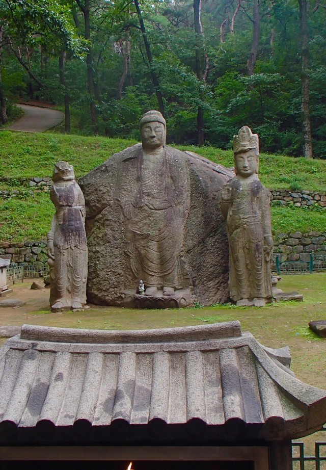 Ancient carved Buddha in four directions, the rock has a different image of Buddha on each side